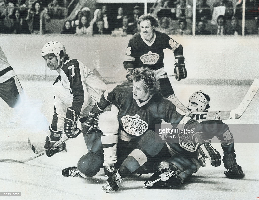 A Collection Of Kings: Los Angeles Kings' goalie Rogie Vachon (right) gets assistance from Sheldon Kannegiesser (6) and Don Kozak as Lanny McDonald of the Toronto Maple Leafs moves toward the Kings' goal in last night's play. Leafs took an early lead; but Kings came back to tie game 4-4.