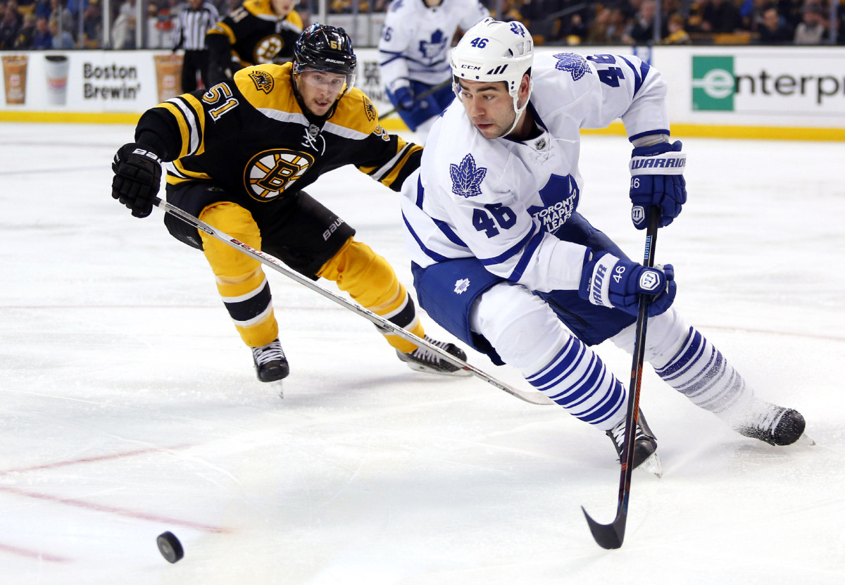 Toronto Maple Leafs defenseman Roman Polak (46) tries to get away from Boston Bruins' Ryan Spooner during the second period of an NHL hockey game in Boston, Saturday, Nov. 21, 2015. (AP Photo/Winslow Townson)